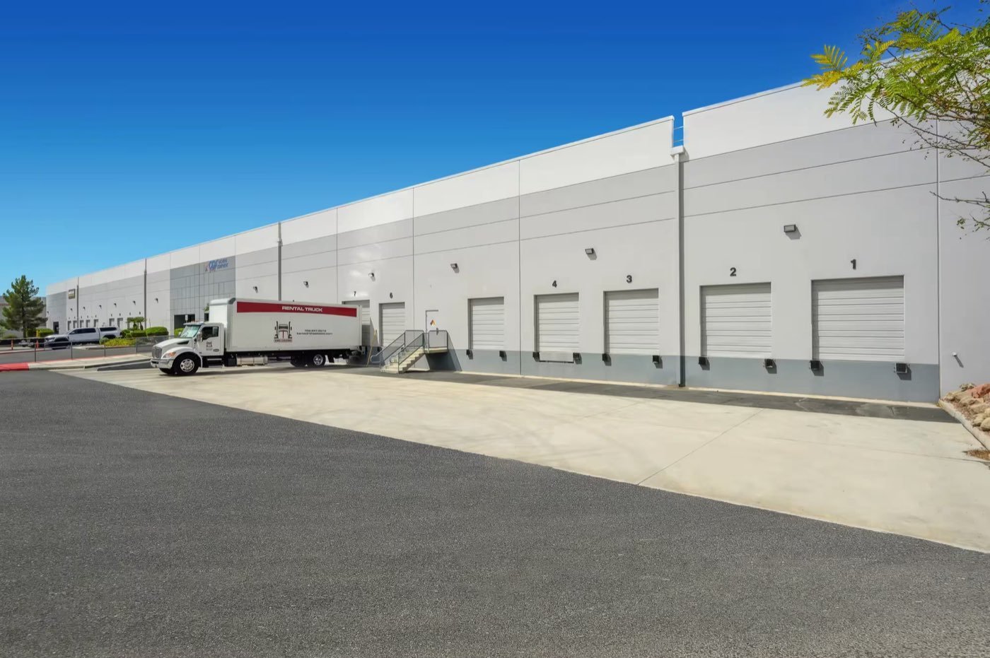 Loading docks at the NIIMBOT USA distribution center in North Las Vegas, Nevada, with a delivery truck at a numbered bay door.